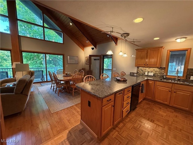 2650 W Buckhorn Dr Unit 823, Millersburg, OH 44654 - kitchen with black dishwasher, a peninsula, dark stone countertops, plenty of natural light, and high vaulted ceiling