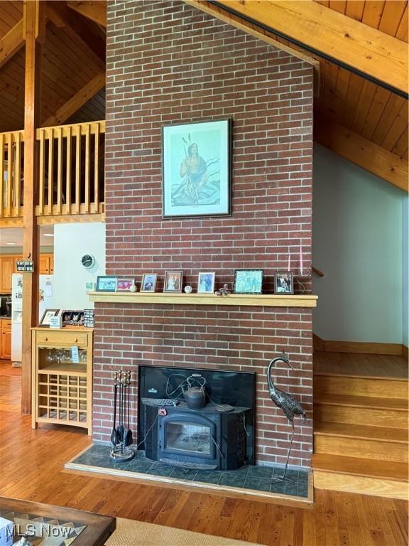 2650 W Buckhorn Dr Unit 823, Millersburg, OH 44654 - living room with wood-type flooring, a fireplace, beamed ceiling, and high vaulted ceiling