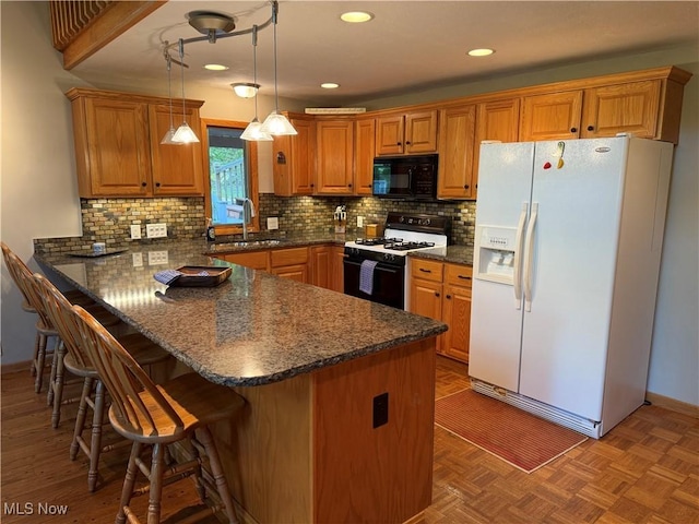 2650 W Buckhorn Dr Unit 823, Millersburg, OH 44654 - kitchen featuring white refrigerator with ice dispenser, range with gas stovetop, black microwave, a peninsula, and brown cabinets