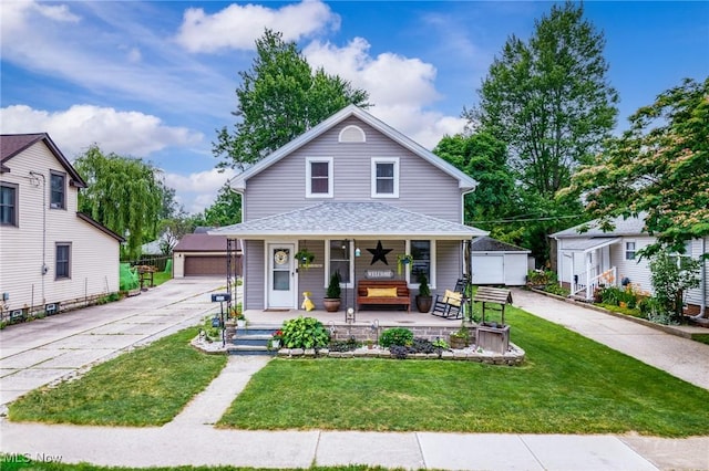 208 Clark St, Berea, OH 44017 - view of front of home with a porch, a garage, an outdoor structure, and a front lawn
