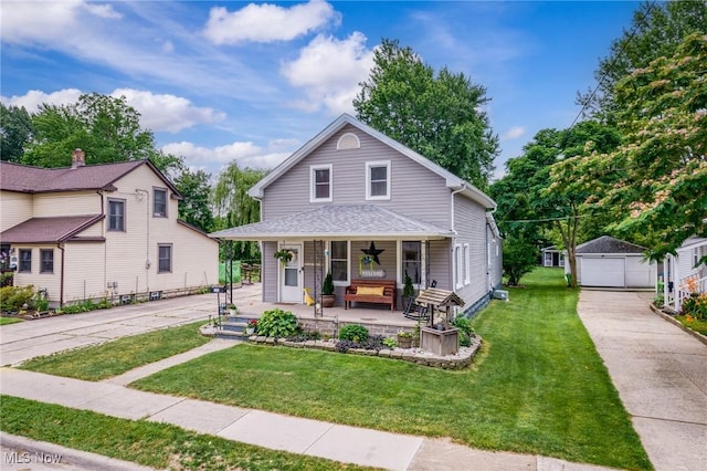 208 Clark St, Berea, OH 44017 - view of front of home with covered porch, an outbuilding, a garage, and a front yard