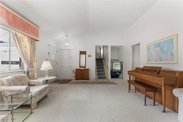 24622 Mitchell Dr, North Olmsted, OH 44070 - carpeted living room with vaulted ceiling and stairway