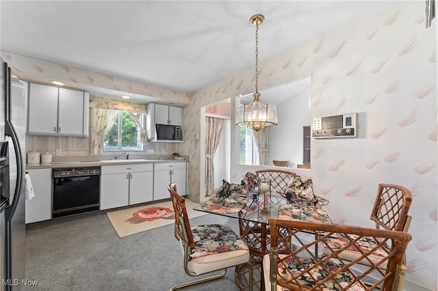 24622 Mitchell Dr, North Olmsted, OH 44070 - dining area featuring wallpapered walls, a chandelier, and carpet flooring