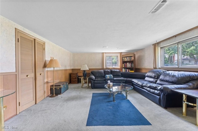 24622 Mitchell Dr, North Olmsted, OH 44070 - carpeted living room featuring plenty of natural light, a wainscoted wall, and wallpapered walls