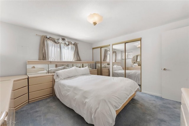 24622 Mitchell Dr, North Olmsted, OH 44070 - bedroom featuring multiple closets and dark carpet