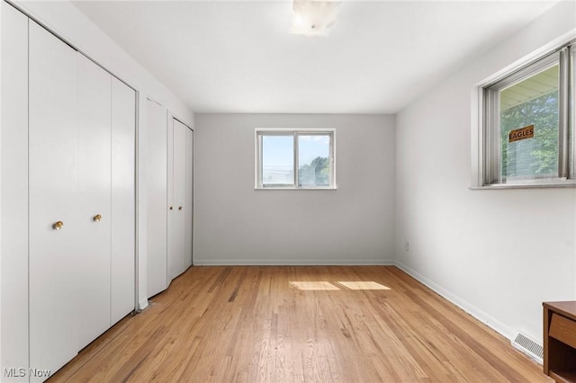 24622 Mitchell Dr, North Olmsted, OH 44070 - unfurnished bedroom with multiple closets and light wood-style flooring