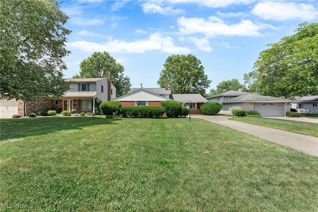24622 Mitchell Dr, North Olmsted, OH 44070 - traditional home with concrete driveway, a front lawn, and an attached garage