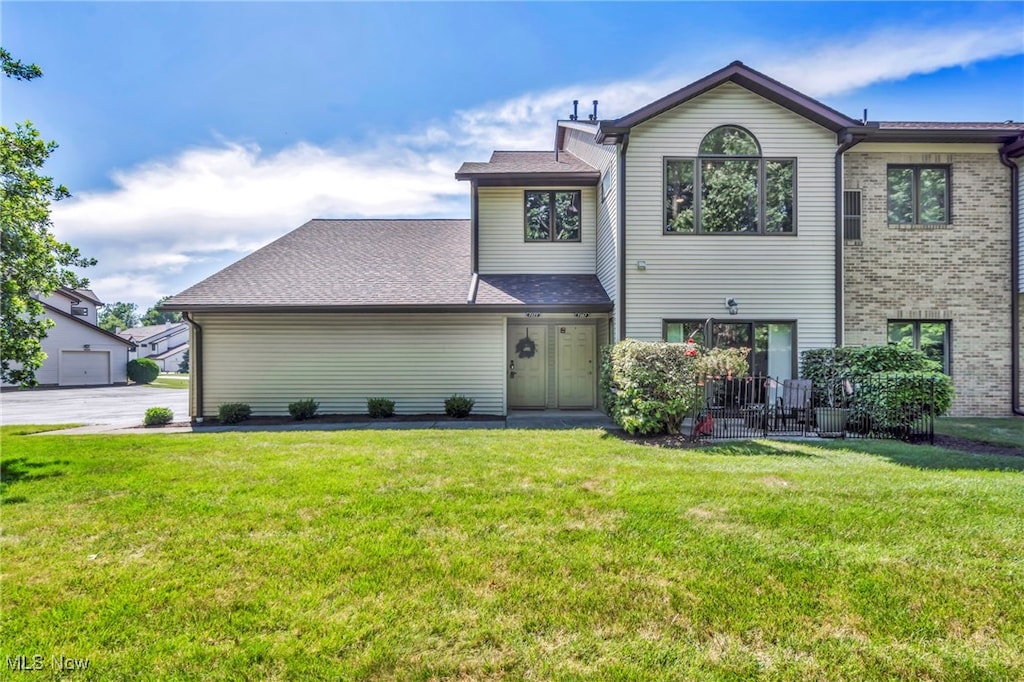 7177 Village Dr, Concord, OH 44060 - view of front facade featuring a front lawn and brick siding