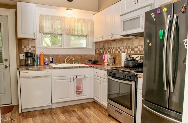 877 W Nimisila Rd, New Franklin, OH 44319 - kitchen featuring stainless steel appliances, white cabinets, tasteful backsplash, and light wood-style floors