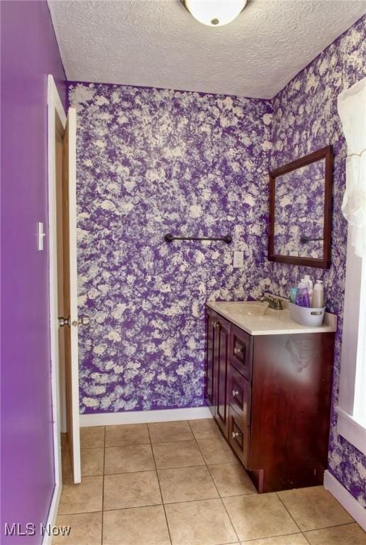 877 W Nimisila Rd, New Franklin, OH 44319 - bathroom featuring wallpapered walls, a textured ceiling, vanity, and tile patterned flooring