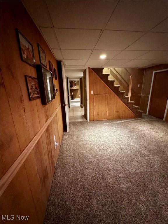 54431 Maple Ln, Martins Ferry, OH 43935 - hallway with stairway, carpet flooring, a drop ceiling, and wooden walls