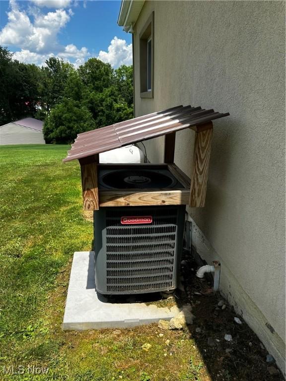 54431 Maple Ln, Martins Ferry, OH 43935 - exterior view of stucco siding and a cooling unit