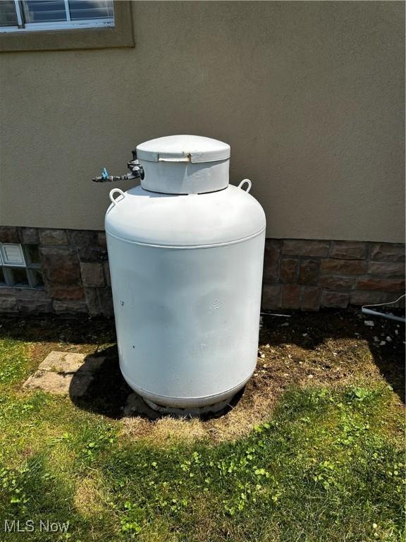 54431 Maple Ln, Martins Ferry, OH 43935 - exterior view of gas tank and stucco siding