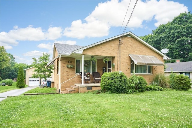 661 Wynne Dr, Coventry, OH 44319 - rear view of property featuring a porch, brick siding, a yard, and driveway