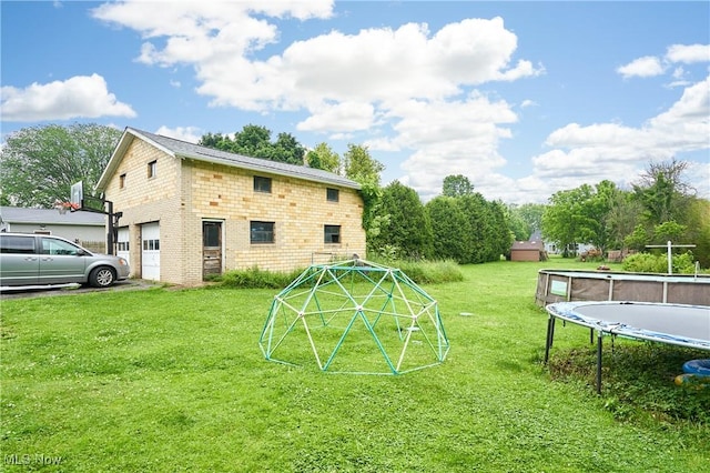 661 Wynne Dr, Coventry, OH 44319 - view of green lawn with a trampoline