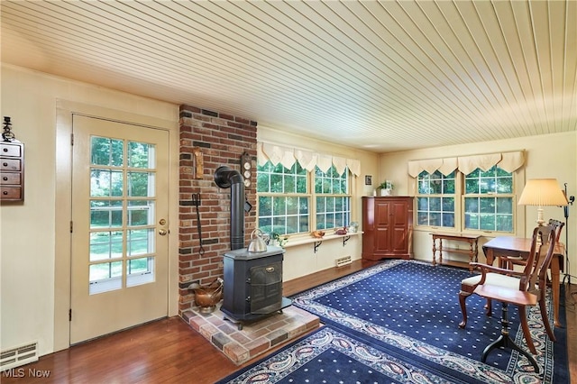 11715 Dunham Rd, Sagamore Hills, OH 44067 - entryway featuring wooden ceiling, plenty of natural light, a wood stove, and wood finished floors