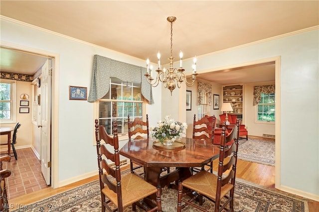 11715 Dunham Rd, Sagamore Hills, OH 44067 - dining space with a chandelier, crown molding, wood finished floors, and built in features
