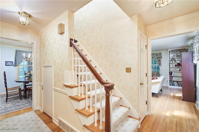 11715 Dunham Rd, Sagamore Hills, OH 44067 - staircase with wood finished floors and wallpapered walls
