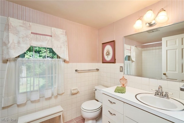 11715 Dunham Rd, Sagamore Hills, OH 44067 - bathroom with vanity, a shower, wallpapered walls, tile walls, and wainscoting