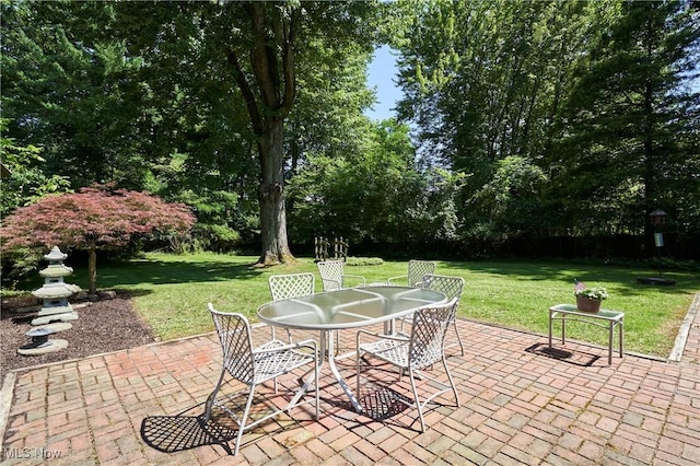 11715 Dunham Rd, Sagamore Hills, OH 44067 - view of patio featuring outdoor dining space and view of wooded area