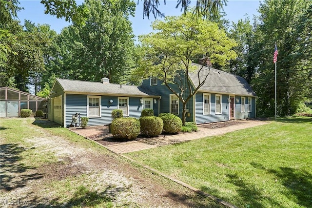 11715 Dunham Rd, Sagamore Hills, OH 44067 - view of front facade with a chimney, a front yard, and dirt driveway