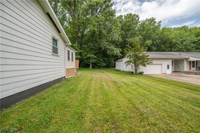 2364 Earl, Niles, OH 44446 - view of green lawn featuring a garage and driveway