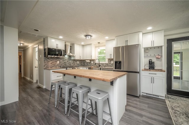 2364 Earl, Niles, OH 44446 - kitchen featuring stainless steel appliances, wooden counters, a breakfast bar area, healthy amount of natural light, and a textured ceiling