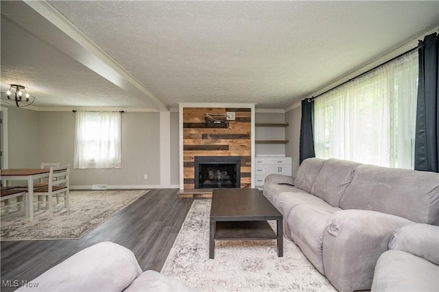 2364 Earl, Niles, OH 44446 - living room featuring a textured ceiling, wood finished floors, a large fireplace, and a chandelier