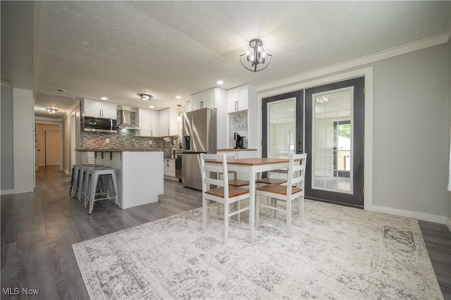 2364 Earl, Niles, OH 44446 - dining space with french doors, wood finished floors, a textured ceiling, ornamental molding, and recessed lighting