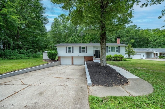2364 Earl, Niles, OH 44446 - raised ranch with an attached garage, brick siding, driveway, a chimney, and a front lawn