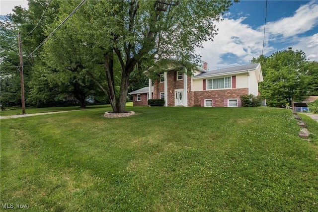 399 Abbyshire Rd, Akron, OH 44319 - view of front of property with brick siding, a chimney, and a front lawn