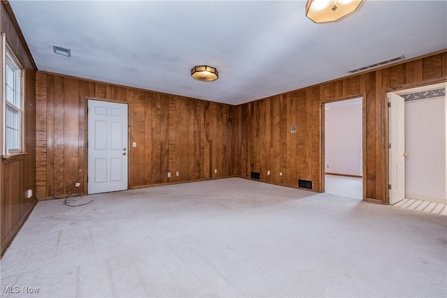 399 Abbyshire Rd, Akron, OH 44319 - spare room featuring wood walls and light colored carpet