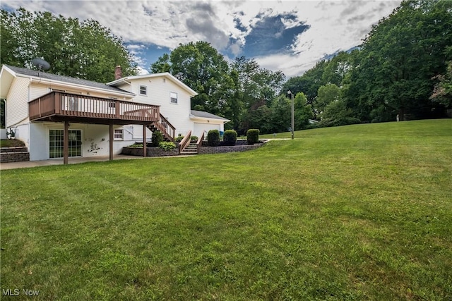 399 Abbyshire Rd, Akron, OH 44319 - view of green lawn featuring stairway, a wooden deck, view of scattered trees, a garage, and a patio area