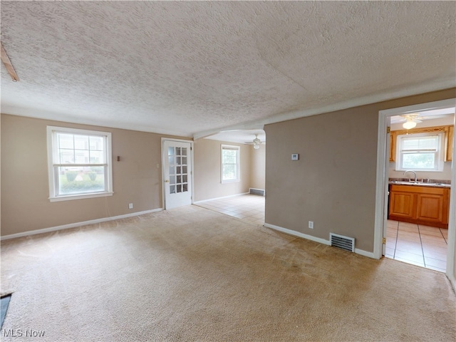 3863 Grosvenor Rd, South Euclid, OH 44118 - unfurnished room featuring ceiling fan, light colored carpet, a textured ceiling, and light tile patterned floors