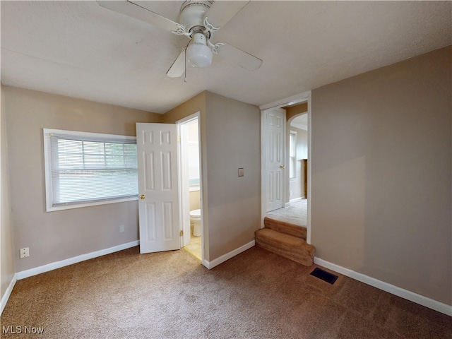 3863 Grosvenor Rd, South Euclid, OH 44118 - unfurnished bedroom with carpet flooring, ensuite bathroom, and ceiling fan