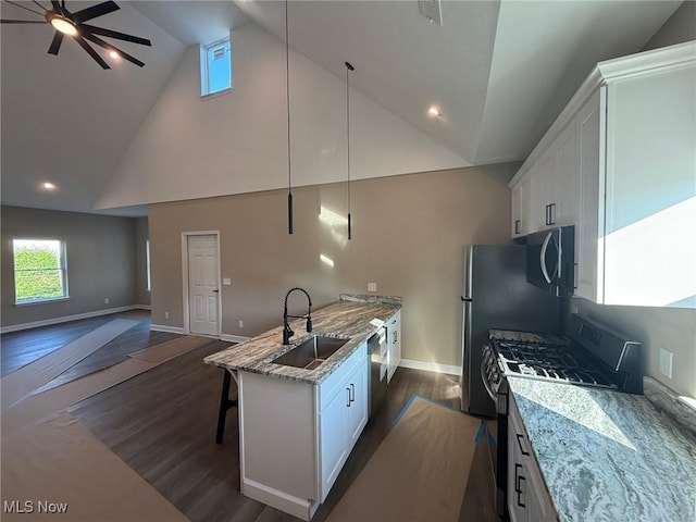 5615 S Blvd, Maple Heights, OH 44137 - kitchen featuring stainless steel appliances, ceiling fan, open floor plan, white cabinetry, and a breakfast bar area