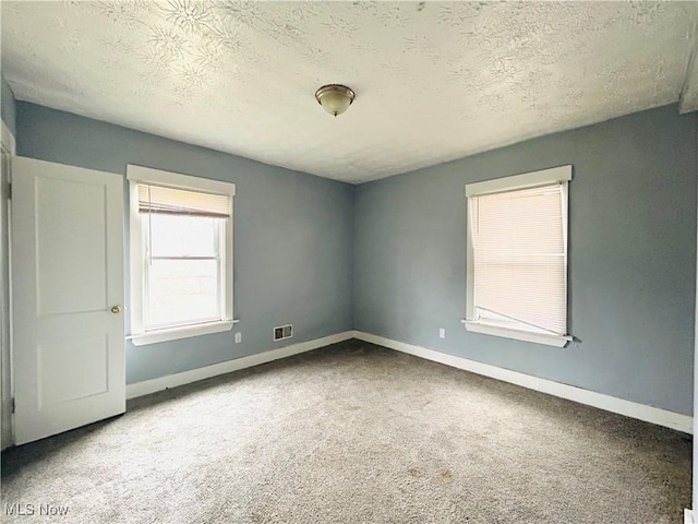 1200 E 125th St, Cleveland, OH 44112 - spare room featuring carpet floors and a textured ceiling