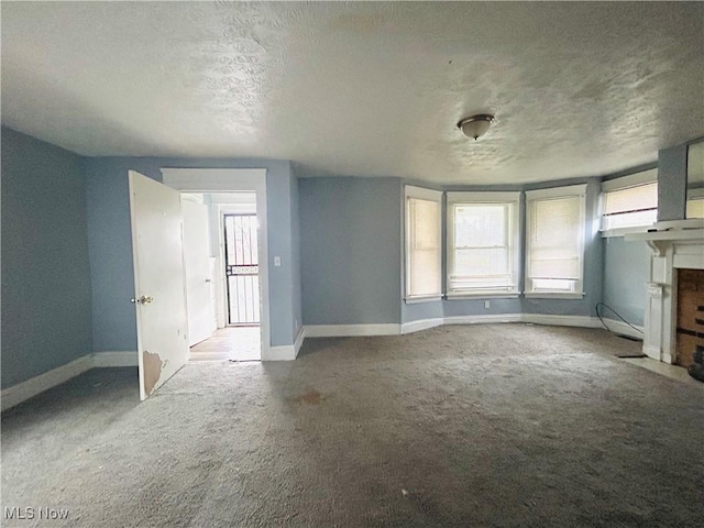1200 E 125th St, Cleveland, OH 44112 - unfurnished living room with carpet floors and a textured ceiling