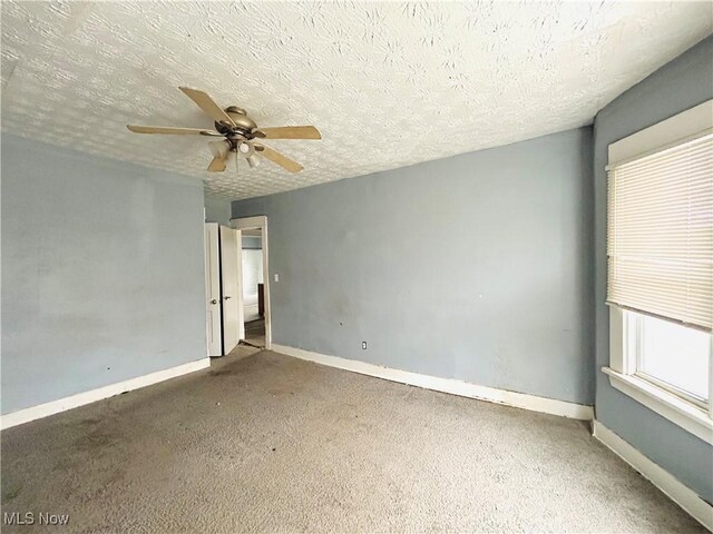 1200 E 125th St, Cleveland, OH 44112 - empty room featuring ceiling fan, carpet flooring, and a textured ceiling