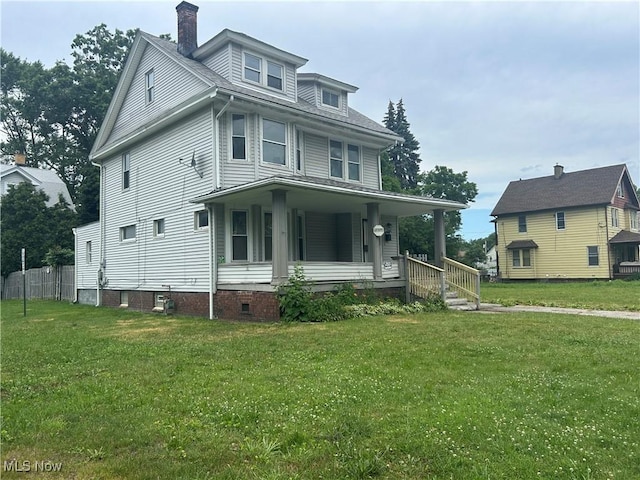 1200 E 125th St, Cleveland, OH 44112 - view of front of house with a porch, a chimney, and a front lawn