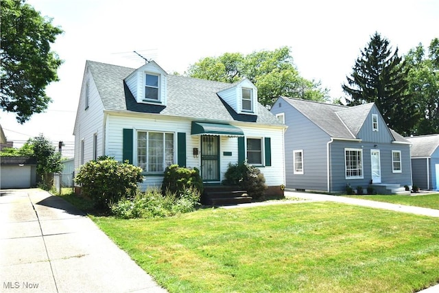 14514 Krems Ave, Maple Heights, OH 44137 - cape cod-style house with an outdoor structure, a front yard, a garage, and roof with shingles