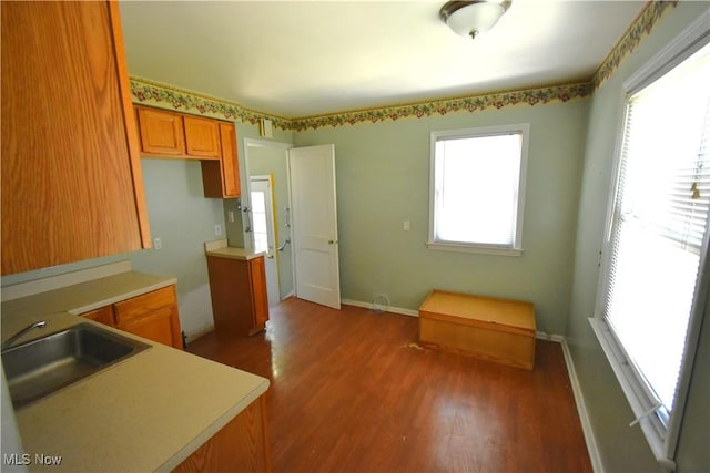 14514 Krems Ave, Maple Heights, OH 44137 - kitchen with wood finished floors, brown cabinets, and light countertops