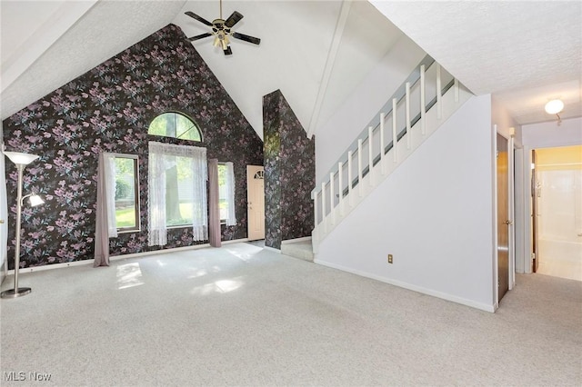 836 Arboretum Cir, Sagamore Hills, OH 44067 - unfurnished living room featuring wallpapered walls, carpet, stairs, vaulted ceiling, and a ceiling fan