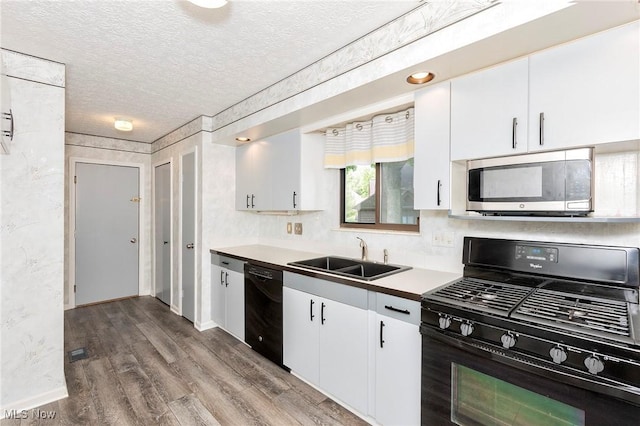 836 Arboretum Cir, Sagamore Hills, OH 44067 - kitchen featuring black appliances, wood finished floors, a textured ceiling, and white cabinets