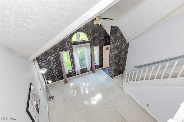 836 Arboretum Cir, Sagamore Hills, OH 44067 - unfurnished living room with wallpapered walls, lofted ceiling, a ceiling fan, a textured ceiling, and carpet