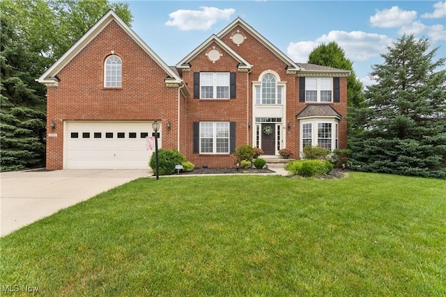 3281 Evans Way, Twinsburg, OH 44087 - colonial inspired home featuring an attached garage, concrete driveway, a front yard, and brick siding