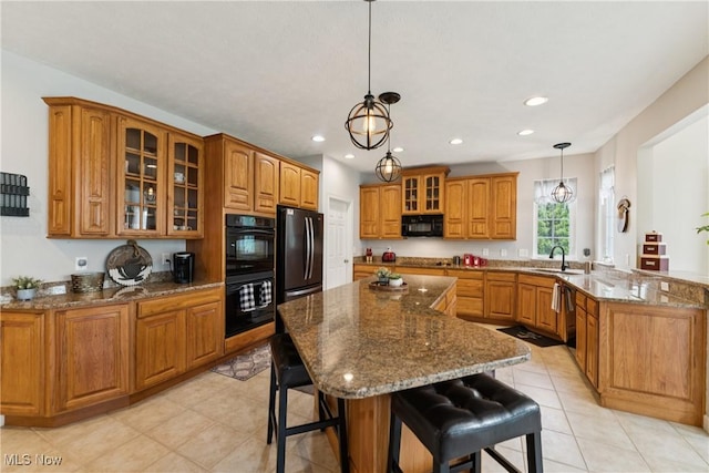 3281 Evans Way, Twinsburg, OH 44087 - kitchen with black appliances, brown cabinetry, a kitchen breakfast bar, glass insert cabinets, and a peninsula