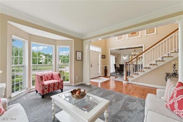 3281 Evans Way, Twinsburg, OH 44087 - living area featuring stairs, plenty of natural light, crown molding, a chandelier, and ornate columns
