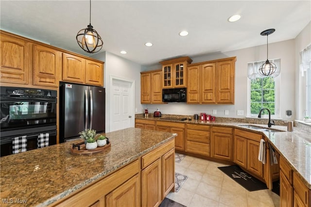 3281 Evans Way, Twinsburg, OH 44087 - kitchen featuring black appliances, dark stone counters, brown cabinets, hanging light fixtures, and glass insert cabinets
