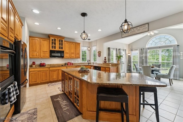 3281 Evans Way, Twinsburg, OH 44087 - kitchen with black appliances, plenty of natural light, brown cabinets, glass insert cabinets, and recessed lighting